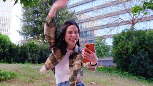  happy young woman wins with an online betting app.