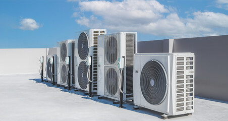 Air conditioning (HVAC) on the roof of an industrial building with blue sky and clouds.