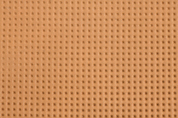 Texture of orthopedic insoles. Brown texture with holes. Insoles close up.