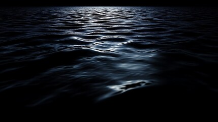 Dark blue water surface with subtle waves reflecting moonlight at night.