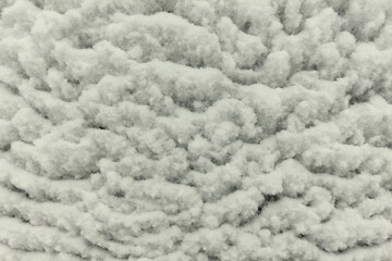 Snow flakes stuck in the form of waves on a white metal sheet.