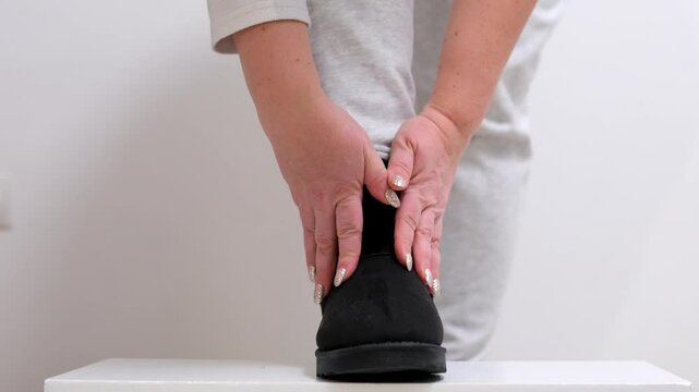 black ugg boots Static Cinematic video of a women wearing black formal shoes and walks