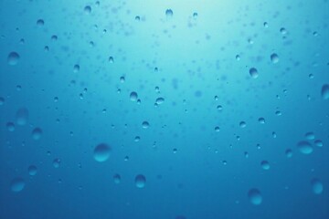 Shimmering Water Droplets on a Blue Background: A Stunning Close-Up of Freshness and Purity