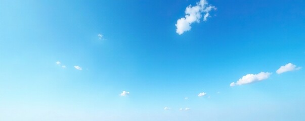 Serene blue sky with a few wispy clouds scattered across the horizon, open, sky