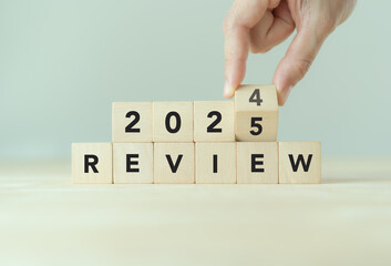 2024 business review, flipping of 2024 to 2025 on wooden blocks. Business and customer review for business strategic planning for the next year 2025. End of the year business.