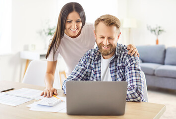 Family couple manages bills, payments, and debt at home using a laptop. Working together on financial tasks, handling accounting, highlighting teamwork in managing household expenses.