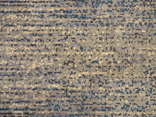 Random design carpet rug with blue and grey color. Strips linear lines or stripes pattern, in modern geometric lines. Blue, beige, and grey color tuft background texture.