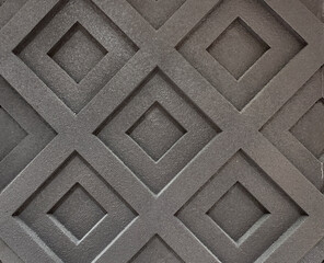 Close up of black layered diamond tiles. Porcelain clay moulded tiles in diamond pattern and black paint, seamless background texture