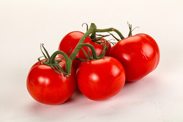 Ripe fresh tomato on the branch