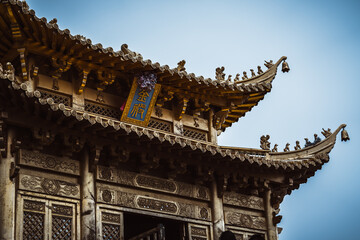Ancient Chinese temple architecture in Yunnan's Dali.  Intricate carvings adorn weathered wood and...