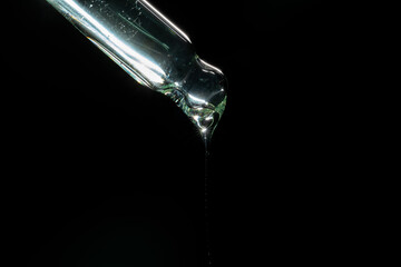 liquid aqua serum lotion dropper of beauty cosmetic skincare, product branding on black background