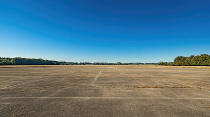 Fototapeta premium Vast Empty Concrete Space Under Clear Blue Sky in Daylight