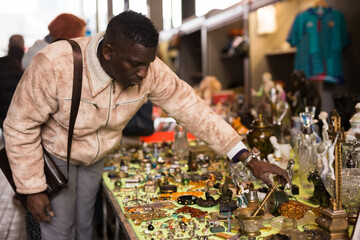 Man chooses antiques at a flea market