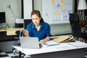 Stress businesswoman is sitting at table, under stress from working.