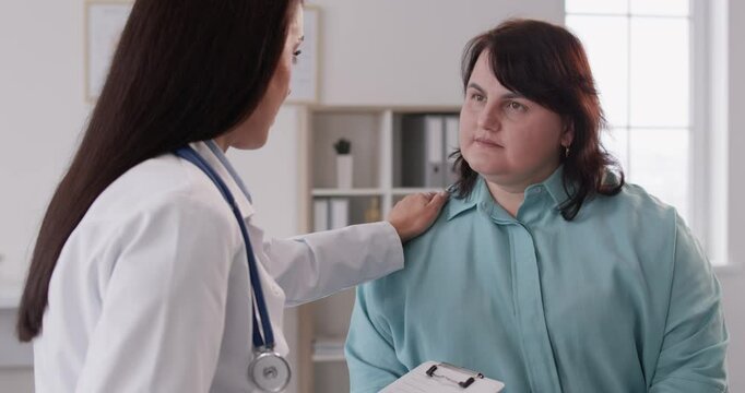 Female doctor attends to an overweight, fat patient in a hospital clinic. Engaging in a supportive conversation, the healthcare professional nurse giving medical advices with empathy and expertise.