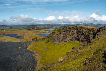 Gorgeous landscape with unique basalt arch on Dyrholaey Endless Beach Nature Reserve on Atlantic South Coast