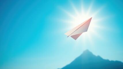 A solitary paper airplane soars through a vibrant, azure sky, bathed in the warm glow of the sun, towards a distant, hazy mountain range.