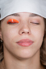 Caucasian woman undergoing eyelash lamination procedure. 