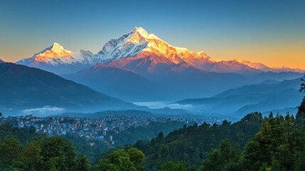 Majestic sunrise illuminates snow-capped Himalayan mountain range overlooking valley town.