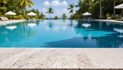 Fototapeta premium A vibrant view of a swimming pool with a clear blue water surface in the background. The foreground features a granite countertop. In the distance, there are white umbrellas and palm trees , suggestin