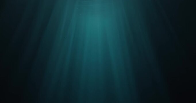 Stunning high-speed 4K slow-motion footage of underwater god rays piercing the ocean surface.  Enchanting beams of light flickering&mdash; ideal VFX background for diving, snorkelling, and summer adventures