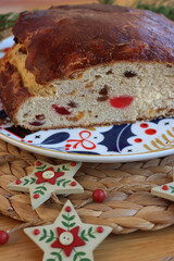Christollen. Tradiotional sliced bread with candied fruits made for Christmas on a plate on wooden table