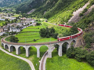 Aerial view of a Bernina Express train crossing the Brusio spiral viaduct, Grisons canton,...