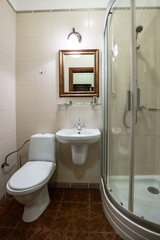 A bathroom with a white toilet, sink, and shower