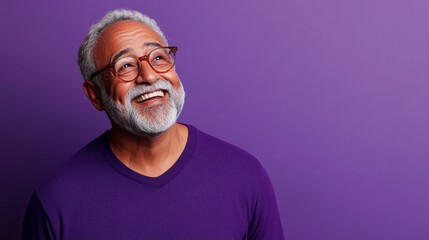 Obraz premium Man with glasses is smiling and looking up at the camera
