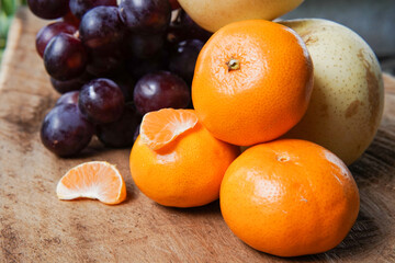 The concept of Tangerine or Mandarin orange with Grapes and Pears on a white background is suitable for design needs, as an illustration for articles about fruits and others.