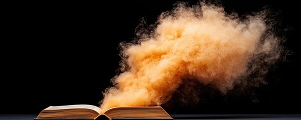Open book releasing a cloud of orange powder against a dark background.