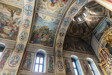 Obraz premium The ceiling of a church is decorated with many paintings of religious figures