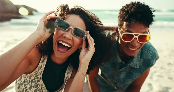 Face, laughing and sunglasses with happy couple on beach together for romantic holiday, travel or vacation. Fun, portrait and smile of man with woman on tropical island paradise for bonding in summer