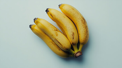Ripe Banana Bunch: Four organically grown, slightly speckled bananas form a visually appealing bunch, ready to be enjoyed.  A close-up overhead shot showcases their natural curves and color. 
