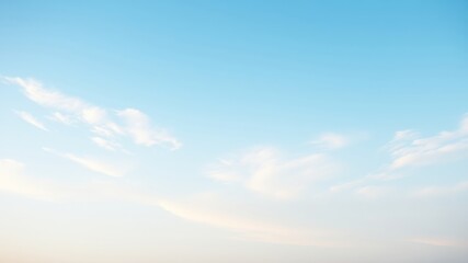 Obraz premium Serene Pastel Sky Delicate wisps of clouds drift across a pale blue expanse.