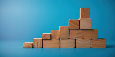 Obraz premium Ascending Wooden Blocks Forming a Staircase on a Blue Background