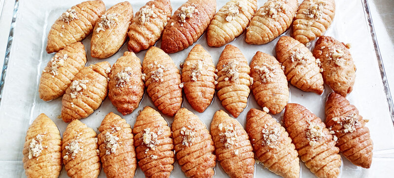 Close-up of Turkish Kalbura Basti cookies coated in sugar syrup. Sweet pastries as part of the restaurant menu.