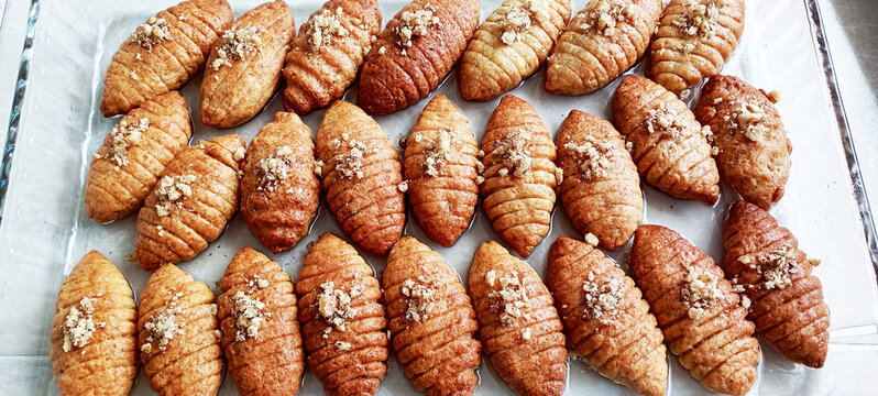 Close-up of Turkish Kalbura Basti cookies coated in sugar syrup. Sweet pastries as part of the restaurant menu.