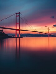 Obraz premium Bosphorus Strait at dusk, with the Istanbul Bridge glowing under the warm colors of the setting sun.