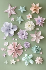 A collection of paper flowers and stars are arranged on a green background