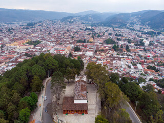 Obraz premium Aerial Drone shot of Church Iglesia de San Cristobalito on the mountain in San Cristobal de Las Casas, Chiapas, Mexico