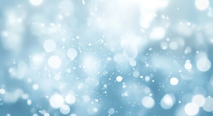 Abstract light blue bokeh background with bright sparkles and glowing particles.