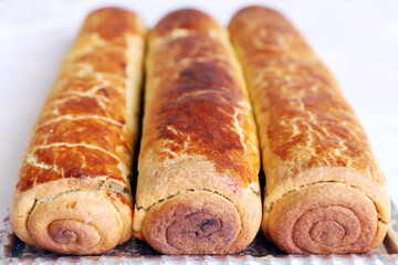 Composition of homemade walnut and poppy seed rolls aka beigli in Hungary. Traditional hungarian christmas or easter cake bejgli at christmastime. Freshly baked sweet filled strudel cakes