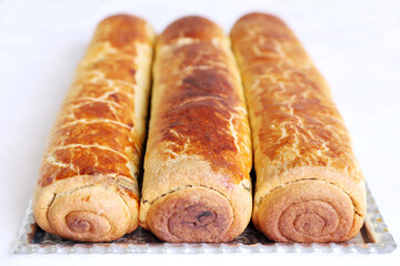 Composition of homemade walnut and poppy seed rolls aka beigli in Hungary. Traditional hungarian christmas or easter cake bejgli at christmastime. Freshly baked sweet filled strudel cakes