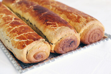 Composition of homemade walnut and poppy seed rolls aka beigli in Hungary. Traditional hungarian christmas or easter cake bejgli at christmastime. Freshly baked sweet filled strudel cakes