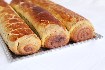 Composition of homemade walnut and poppy seed rolls aka beigli in Hungary. Traditional hungarian christmas or easter cake bejgli at christmastime. Freshly baked sweet filled strudel cakes