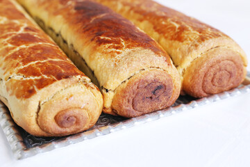 Composition of homemade walnut and poppy seed rolls aka beigli in Hungary. Traditional hungarian christmas or easter cake bejgli at christmastime. Freshly baked sweet filled strudel cakes