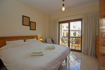 Interior design of bedroom in house with balcony