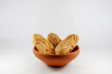 Bengali dessert Goja or Khaza on a bowl. Goja is made of flour and ghee, deep fried and soaked in sugar syrup. It is a popular sweet prepared during festivals like Diwali, Holi, Eid