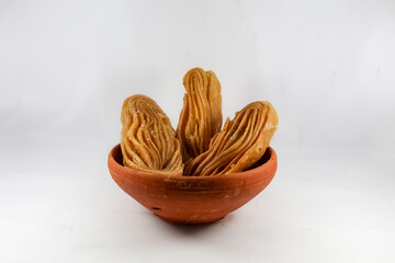 Bengali dessert Goja or Khaza on a bowl. Goja is made of flour and ghee, deep fried and soaked in sugar syrup. It is a popular sweet prepared during festivals like Diwali, Holi, Eid